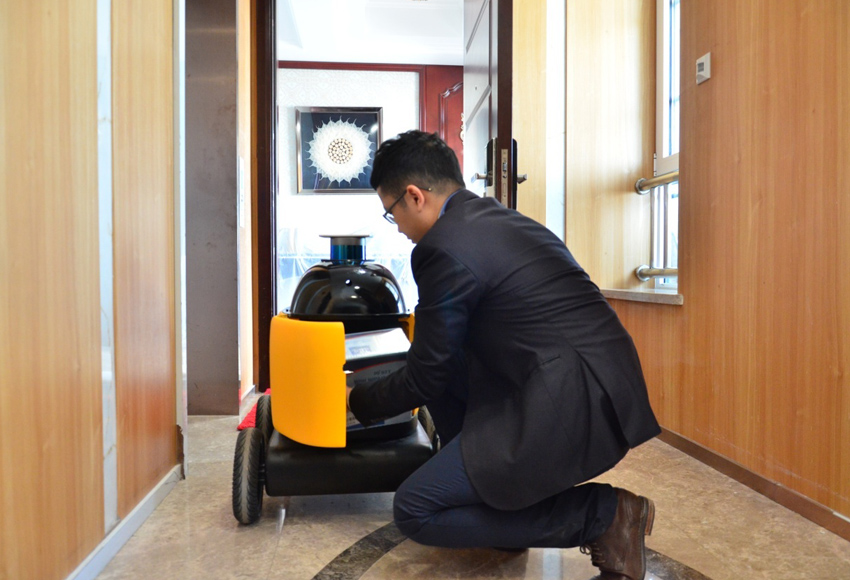 市民从无人快递车上收货