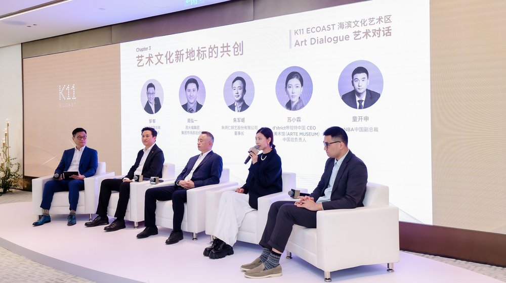 A group of people sitting on a stageDescription automatically generated