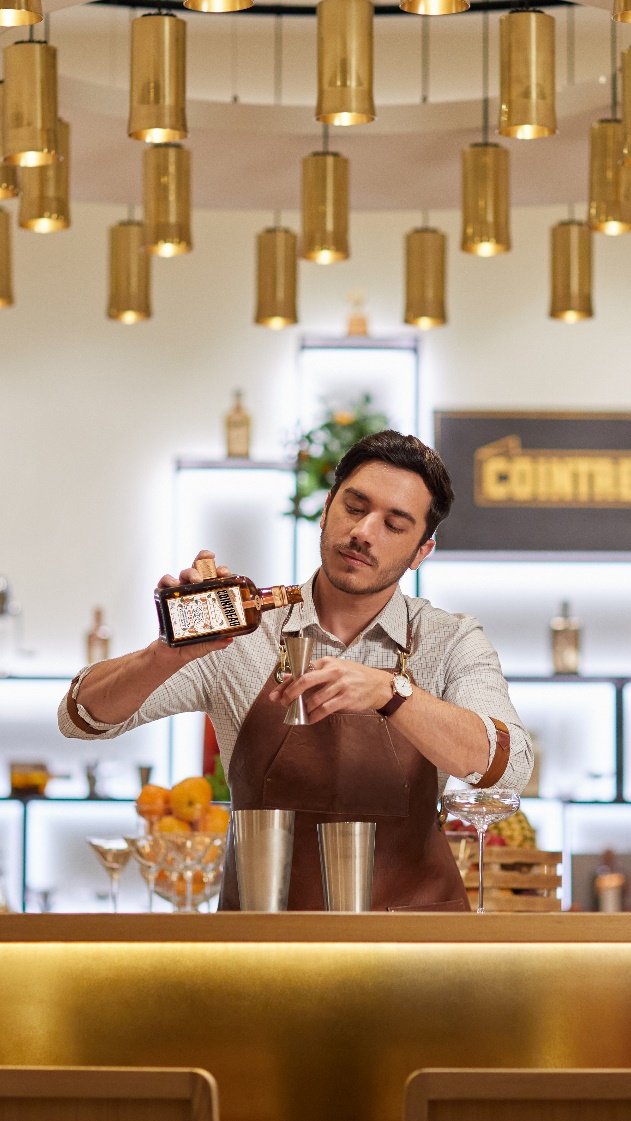 A person pouring a drink into a glassAI-generated content may be incorrect.